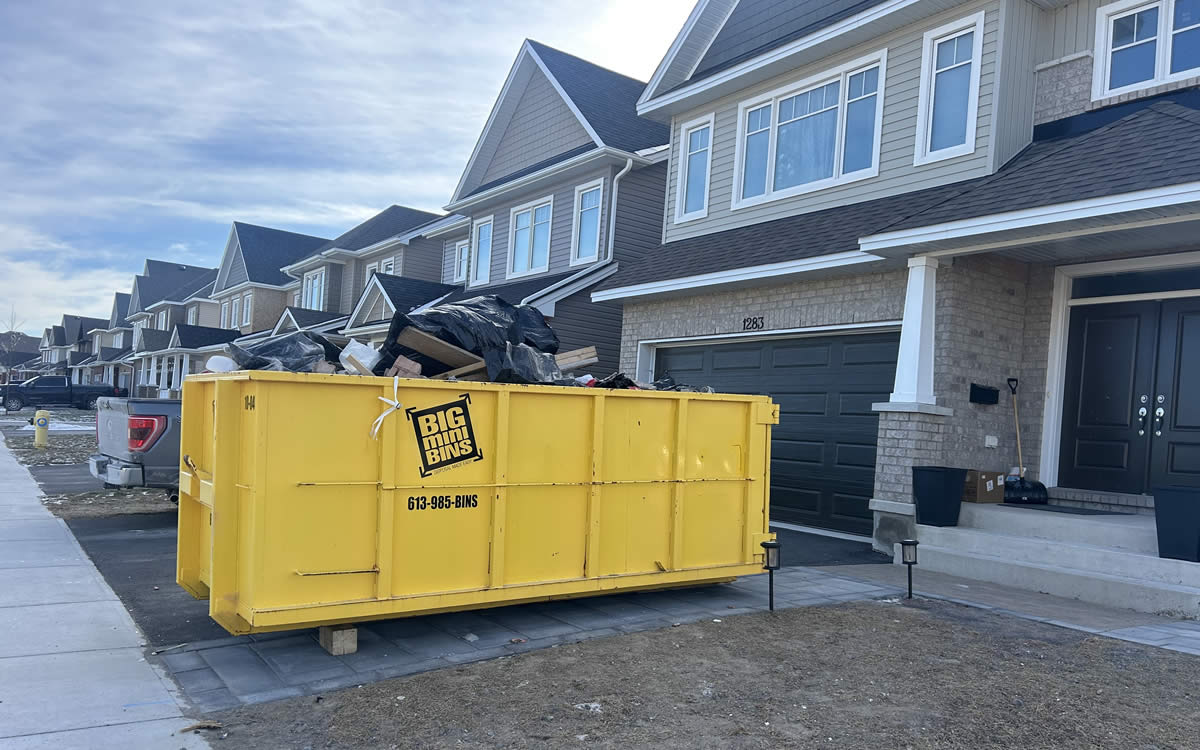 kingston dumpster rentals yellow big mini bins dumpster in Kingston Ontario driveway